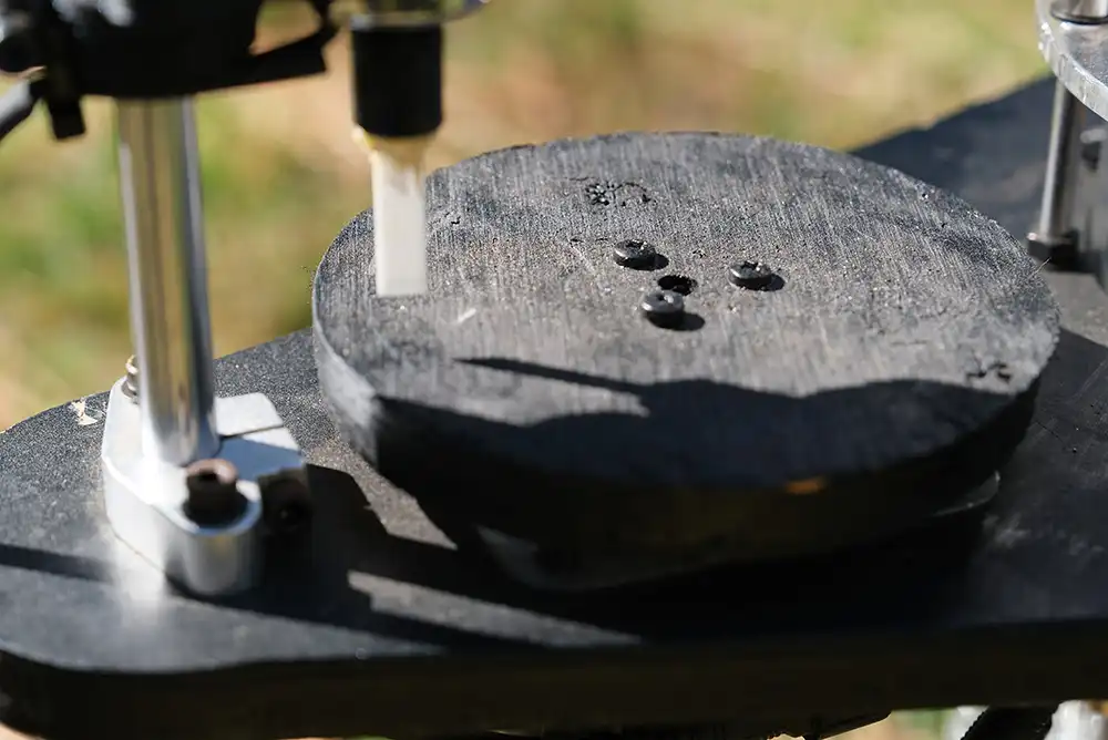 From left to right close ups of the wooden turn-table and ceramic pecking components of the woodpecking mechanism